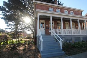 San Francisco triplex for rent - the front of a brick house with a porch and stairs