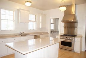 San Francisco triplex for rent - a large white kitchen with a stove and a sink