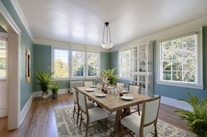 San Francisco triplex for rent - a dining room with blue walls and a wooden table and chairs
