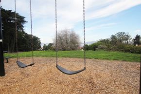 San Francisco triplex for rent - two black swings on a playground in a park