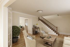 San Francisco triplex for rent - a living room with chairs and a table and a staircase