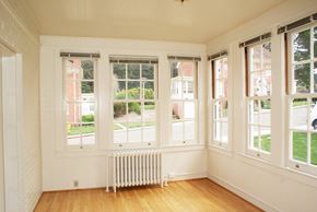 San Francisco triplex for rent - a living room with a radiator and five windows