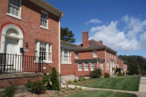 San Francisco triplex for rent - the front and side of a brick building with grass and trees