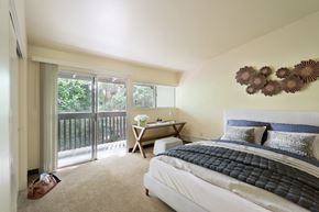 San Francisco townhouse for rent - a bedroom with a bed and a sliding glass door