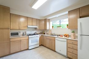 San Francisco townhouse for rent - a large kitchen with wooden cabinets and white appliances