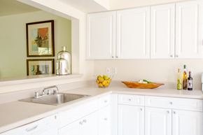 San Francisco townhouse for rent - a white kitchen with white cabinets and a sink