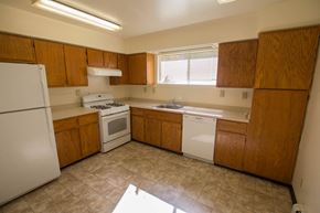 San Francisco townhouse for rent - a kitchen with white appliances and wooden cabinets