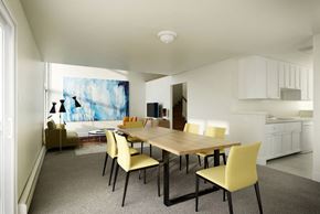 San Francisco townhouse for rent - a dining room with a wooden table and yellow chairs