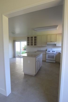 San Francisco townhouse for rent - an empty kitchen with white cabinets and a white counter top