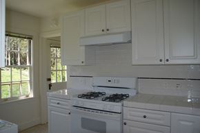 San Francisco triplex for rent - a kitchen with white appliances and white cabinets