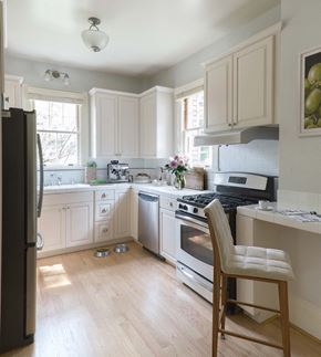 San Francisco triplex for rent - a kitchen with white cabinets and stainless steel appliances