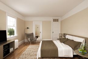 San Francisco triplex for rent - a bedroom with a bed and a chair and a tv
