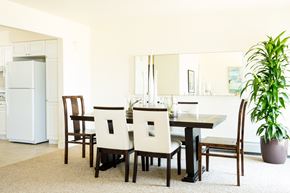 San Francisco townhouse for rent - a dining room with a table and chairs and a plant