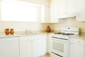 San Francisco townhouse for rent - a kitchen with white appliances and white cabinets