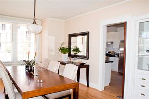 San Francisco triplex for rent - a dining room with a wooden table and white chairs