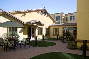 Phoenix apartment for rent - a patio with tables and chairs in front of a house