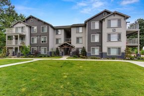 Renton apartment for rent - Front of Avaya Trails with Grass, Walking Path, Gray Apartment Exteriors