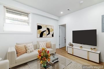 San Francisco apartment for rent - A living room with a couch, a coffee table, and a television.