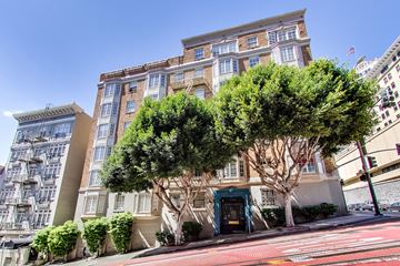 San Francisco apartment for rent - A tree in front of a building with a blue door.