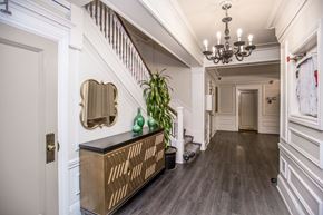 San Francisco apartment for rent - A hallway with a wooden floor and a chandelier.