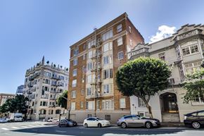 San Francisco apartment for rent - A street view with cars and buildings.