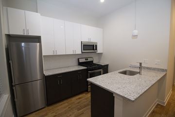 Chicago apartment for rent - a kitchen with granite counter tops and a stainless steel refrigerator
