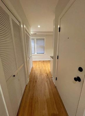 Chicago apartment for rent - a hallway with a door and a hard wood floor