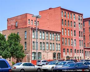 Wichita apartment for rent - a large brick building with cars parked in a parking lot