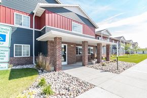 West Fargo apartment for rent - the front of a house with a sidewalk and landscaping