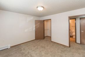 West Fargo apartment for rent - an empty bedroom with a door to a bathroom and a closet