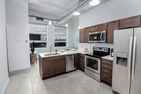 Sioux City apartment for rent - a kitchen with wooden cabinets and stainless steel appliances