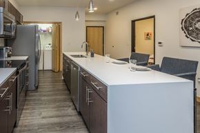 Dakota Dunes apartment for rent - a kitchen with an island and stainless steel appliances and a refrigerator