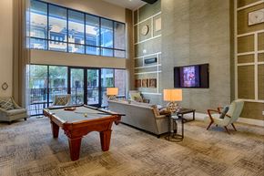 Houston apartment for rent - A room with a pool table, couch, and television.