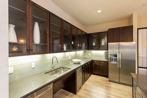 Houston apartment for rent - A modern kitchen with dark wood cabinets and stainless steel appliances.