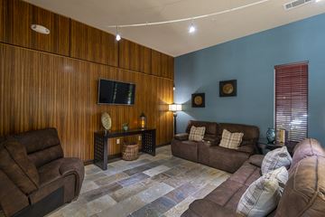 San Antonio apartment for rent - A living room with brown leather furniture and a flat screen TV mounted on the wall.