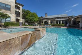 San Antonio apartment for rent - A large swimming pool with a waterfall feature in the middle.