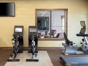 Tomball apartment for rent - a gym with exercise equipment and a large window