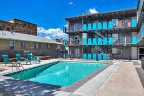 Denver apartment for rent - a swimming pool with a building in the background