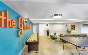 Denver apartment for rent - a game room with a ping pong table and a blue wall with the goal