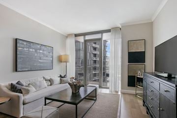 Atlanta apartment for rent - A modern living room with a white sofa and a black coffee table.