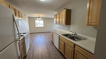 Melrose apartment for rent - A kitchen with wooden cabinets and a white refrigerator.