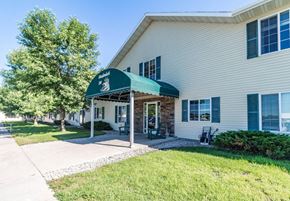 Melrose apartment for rent - A white building with a green awning is the main focus of the image.