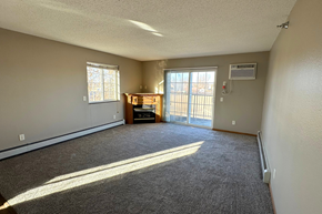 Melrose apartment for rent - A room with a carpeted floor, a window, and a door leading to a balcony.