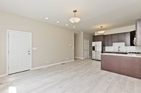 Chicago apartment for rent - an empty kitchen and living room with a refrigerator and a sink
