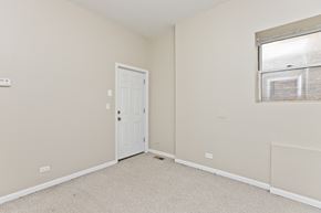 Chicago apartment for rent - a bedroom with a door and a window and a carpeted floor