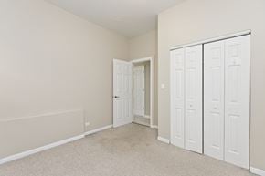Chicago apartment for rent - a bedroom with white closets and a carpeted floor