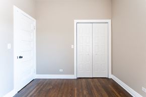 Chicago apartment for rent - a bedroom with two white doors and wood floors