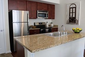 Farmington townhouse for rent - a kitchen with granite counter top and stainless steel appliances