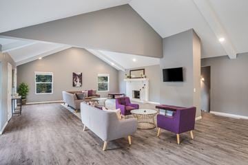 Okemos townhouse for rent - A living room with a grey couch and a purple chair.