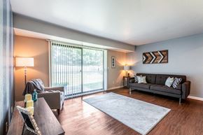 Okemos townhouse for rent - A living room with a couch, chair, and table.